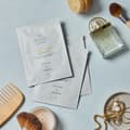 Snow Lotus ansiktsmask från Oslo Skin Lab tillsammans med skönhetsprodukter och accessoarer.